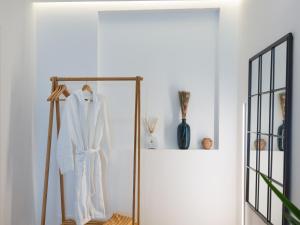 a white robe hanging on a rack in a room at Alvor Serene House I in Alvor +7 photos