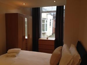 a bedroom with a white bed and a window at Flex Lets - Azalea Terrace Apartments in Sunderland