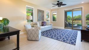 a living room with a couch and a table at SOAK UP THE SUN VILLA Sun-Drenched 3BR KaMilo Home with Golf Course View in Waikoloa +64 photos