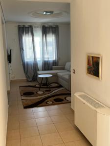 a living room with a couch and a table at Vila Oron in Vlorë