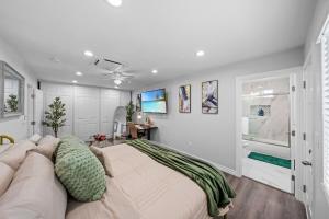 a bedroom with a large bed and a couch at Entire Private 3-Bed 3-Bath House w Yard, King Bed, Prime Location in San Diego +39 photos