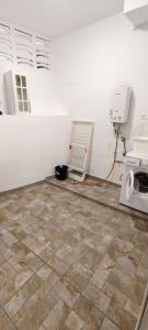 a room with a tile floor and a microwave at Piedras del Teide in Guía de Isora