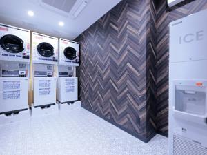 a row of washers and dryers in a laundry room at APA Hotel Tonami Ekimae in Tonami