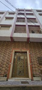 a brick building with a door and a balcony at Dar Tetuan 4 You III in Tetouan