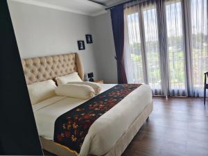 Postel nebo postele na pokoji v ubytování villa nusantara ungasan + 13 fotografií