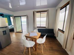 a kitchen and dining room with a table and chairs at Apartamento Lirios del Río in Tortuguero +10 photos