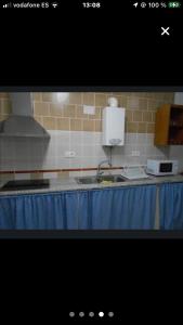 a kitchen with a sink and a counter top at Casa rural Ocaña in La Puebla de los Infantes +1 photo