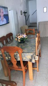 a dining room table and chairs with flowers on it at Casa rural Ocaña in La Puebla de los Infantes
