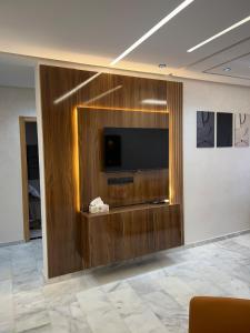 a room with a flat screen tv on a wall at Very nice modern air-conditioned apartment in Fez in Fès +19 photos