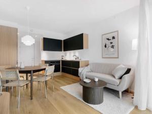 a living room with a couch and a table at 5 star holiday home in Aarhus C in Aarhus