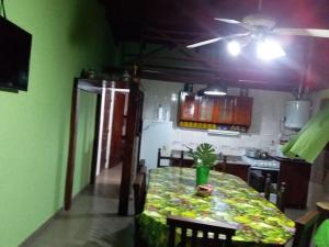 a dining room with a table and a kitchen at Cabañas Los Abuelos in Santa Rosa de Calamuchita +4 photos