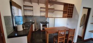 a small kitchen with a table and a dining room at La Casita del Monte in San Miguel del Monte +22 photos