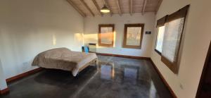 a bedroom with a bed in the middle of a room at La Casita del Monte in San Miguel del Monte