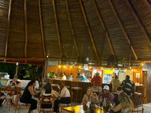 a group of people sitting at tables in a restaurant at Jardines del Golfo in Lepanto