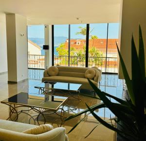a living room with a couch and a table at Hôtel Villa Martini in Ajaccio