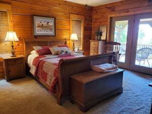 a bedroom with a bed in a log cabin at Come Enjoy the Mountain Sunsets, Near Asheville in Mars Hill