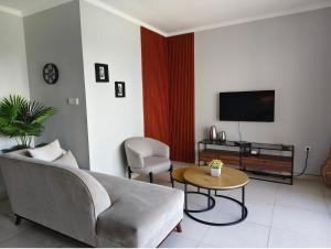 a living room with a couch and a table at villa nusantara ungasan in Uluwatu