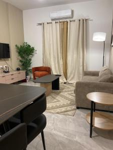 a living room with a couch and a table at Cosy, accessible, comme et sécure in Kinshasa