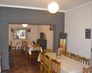 a dining room with tables and chairs and a room with tables and chairsktop at Hostel Urqu Ñan in Mendoza