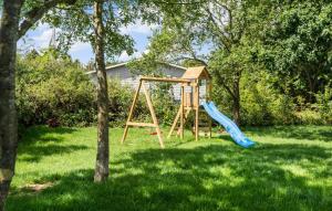 a playground with a slide in a yard at Stunning Home In Odder With Sauna in Odder