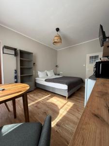 a bedroom with a bed and a table at Dom na Północy in Władysławowo
