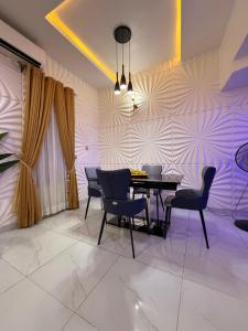 a dining room with a table and chairs at Beautifully furnished 4 Bedroom Duplex in Lekki