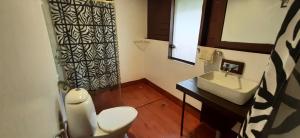 a bathroom with a toilet and a sink at NV Ecofarm in Dabal