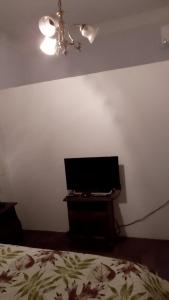 a bedroom with a bed and a desk with a television at Residencia "Libertad" in San Andrés +12 photos