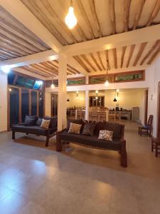 a living room with two couches and a table at Wasini house mkwiro village in Shimoni
