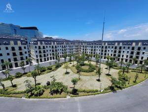 a large building with a park in front of it at Aurelia Hotel in Hai Phong