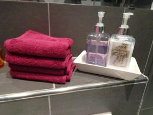 a shelf with towels and a bottle of soap at Residenz am Berg in Leimen +81 photos