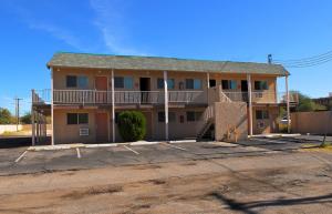 an apartment building with a balcony on a street at Stone Inn Extended Stay U of A in Tucson