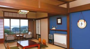 a living room with a table and a tv at Tomoyama Kanko Hotel in Shima +43 photos