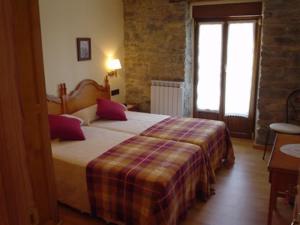 a bedroom with a large bed in a room at Hostal Restaurante Arangoiti in Yesa