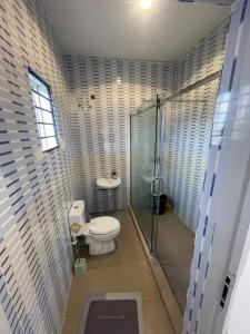 a small bathroom with a toilet and a shower at 2 bedroom terrace in Lekki