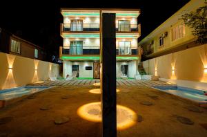 a building with a pool in front of it at night at Adonai villa 1 in Albion