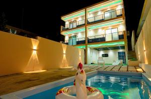 a swimming pool in front of a building at night at Adonai villa 1 in Albion