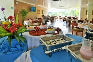 a table with a buffet of food in a restaurant at Gran Hotel De Lago - El Coca in Puerto Francisco de Orellana