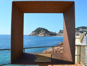 a view of the ocean through a window at Apartments Soleil Tossa 5 in Tossa de Mar