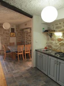a kitchen and dining room with a table and chairs at Fischer Fritz 2 in Betina