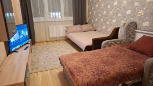 a room with a bed and a tv and a couch at Imanta Apartment Riga 2х Rooms 52м2 in Rīga