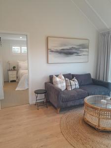 a living room with a couch and a table at Coulson Cottage in Greymouth
