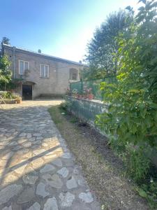 a stone walkway in front of a building at Vino Vista in Tʼelavi +92 photos