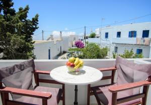 a bowl of fruit on a table on a balcony at Pension Ilias - Chora Amorgos in Amorgos