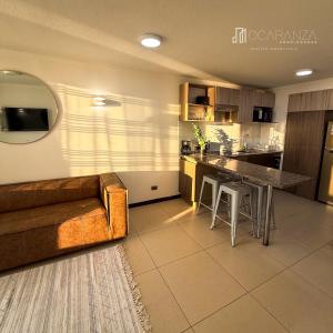 a kitchen and living room with a couch and a table at Hermoso Depto sector Enjoy in Coquimbo +9 photos