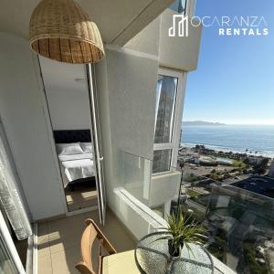 a balcony with a table and a view of the ocean at Hermoso Depto sector Enjoy in Coquimbo