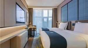 Katil atau katil-katil dalam bilik di Echarm Hotel Xi'an Dayan Tower Datang Lively District