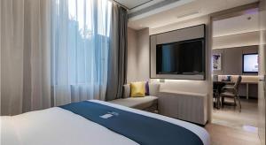 Katil atau katil-katil dalam bilik di Echarm Hotel Xi'an Dayan Tower Datang Lively District