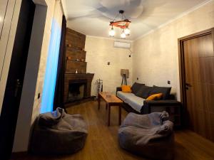 a living room with a couch and a fireplace at Cottage "Soulmate" in Ambrolauri