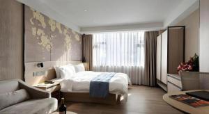 Postel nebo postele na pokoji v ubytování Shenzhen Hanyong Hotel Fuyong Branch